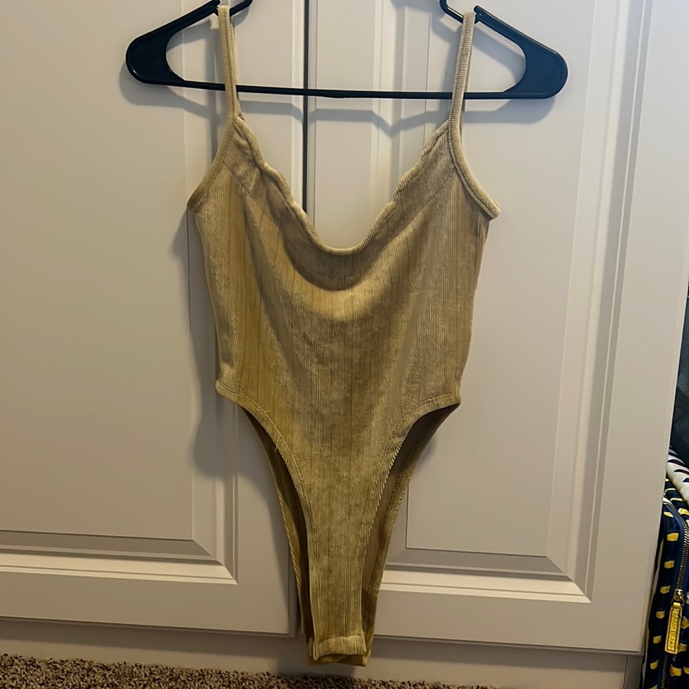 High leg, tan colored, cow neck body suit